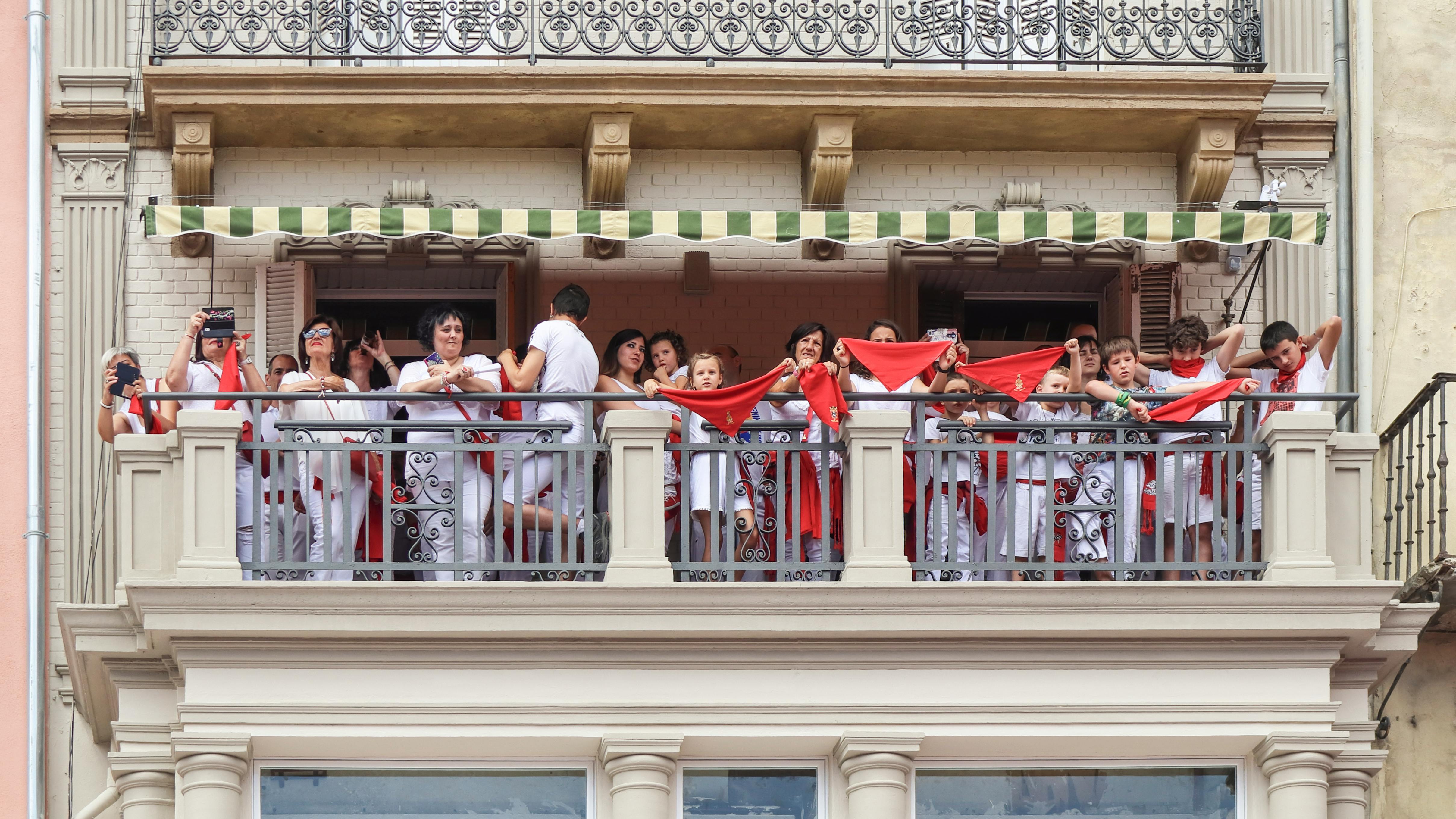 Revelers on balconies holding their red pa&ntilde;uelos up in the air, waiting for the txupinazo rocket to fire and start the San Ferm&iacute;n festival