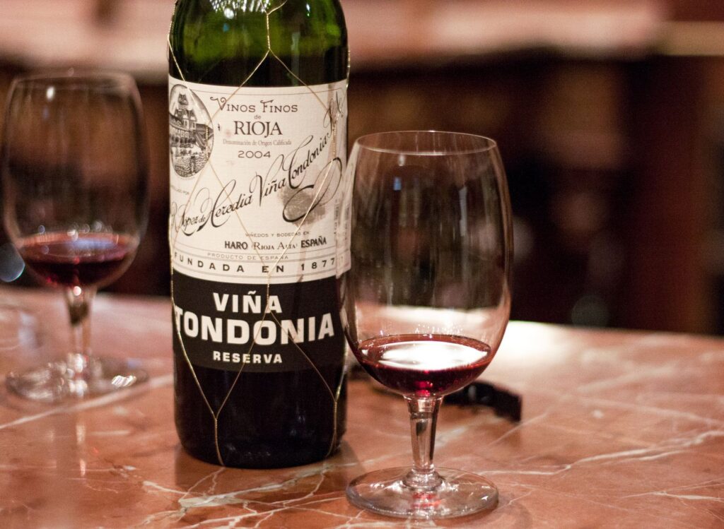 Viña Tondonia Reserva rioja wine bottle and glass on marble counter in Rioja Spain