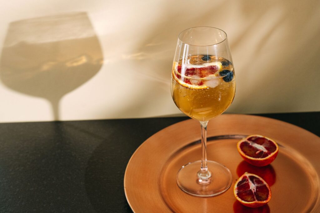 Orange cava and citrus cocktail in a wide glass, in the style of Agua de Valencia