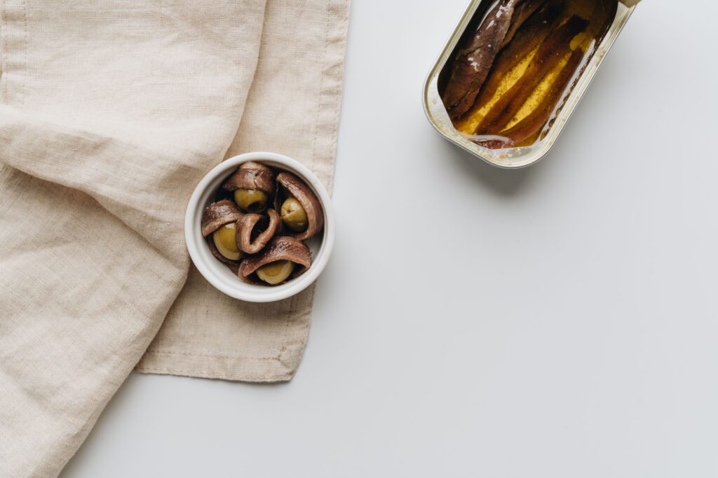 Cured anchoas and vinegar-marinated boquerones served with olives