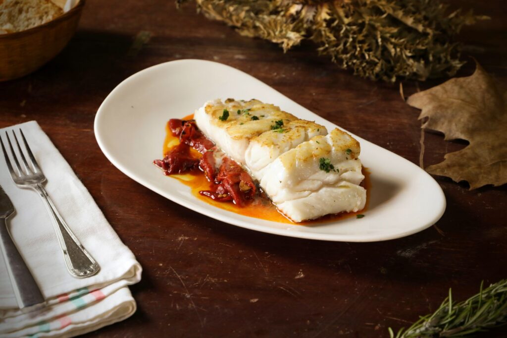 Bacalao al ajoarriero — grilled white fish with tomato sauce, a staple of Pamplona cuisine during San Fermín