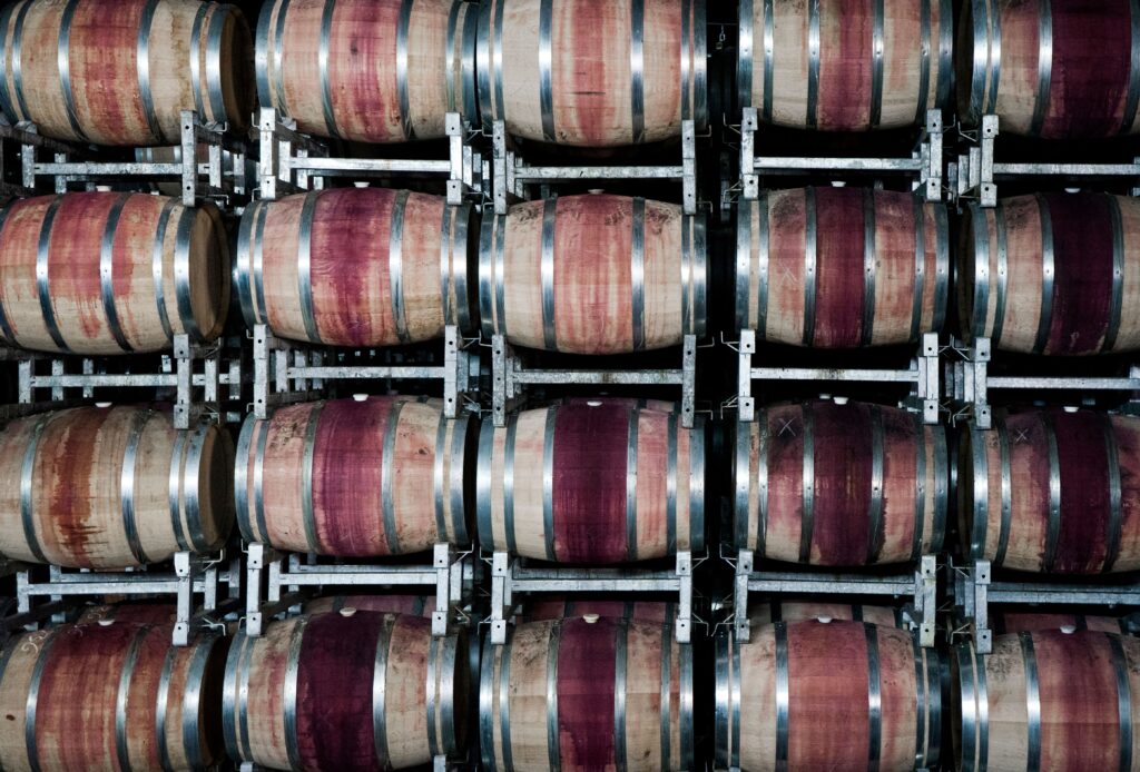 Stacked oak wine barrels aging in a Rioja bodega cellar, Haro