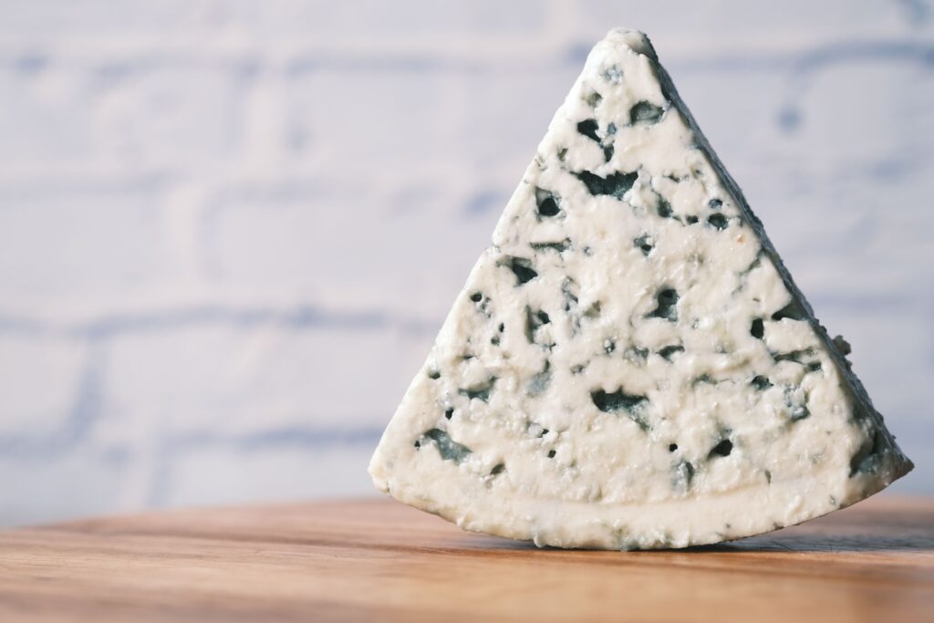 Wedge of Cabrales blue cheese from Spain showing its blue-green veining