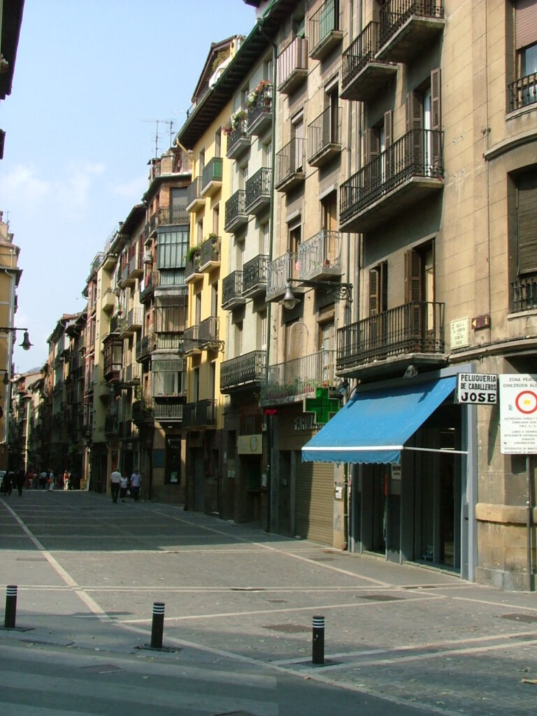 Calle Estafeta street lined with shopfronts and balconies, Pamplona old town