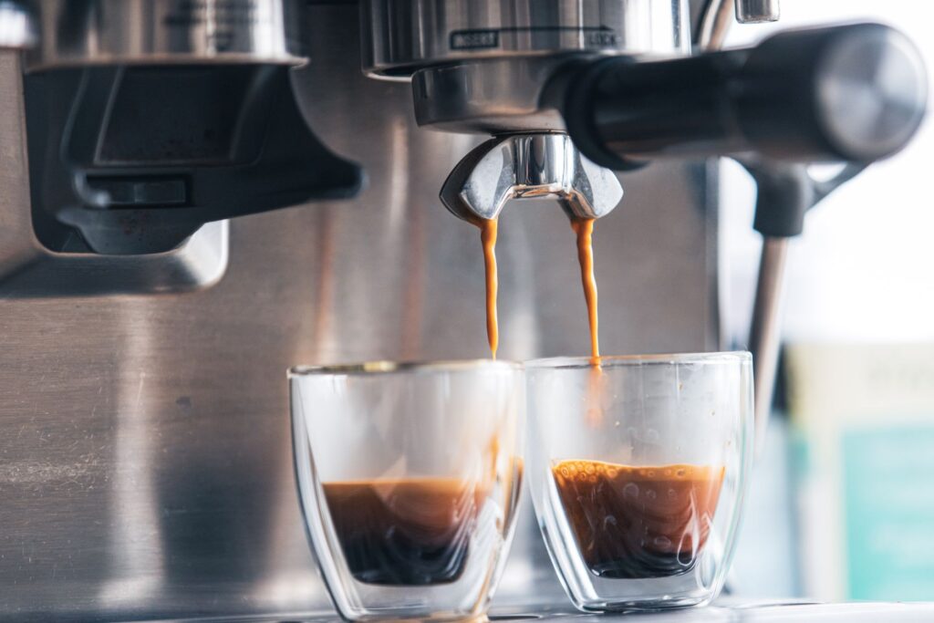 Espresso cortado poured into glass cups at a Spanish cafe bar