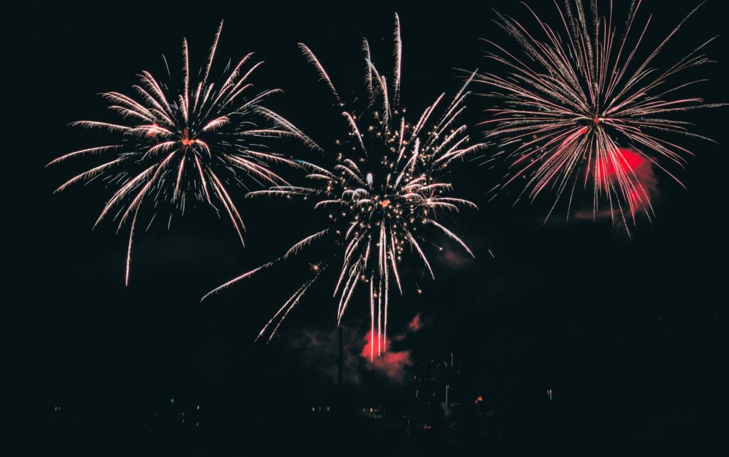 Fireworks bursting across a night sky during a fuegos artificiales San Fermín style display