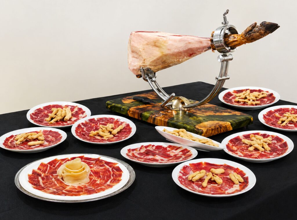 Jamon serrano ham sliced and plated with breadsticks