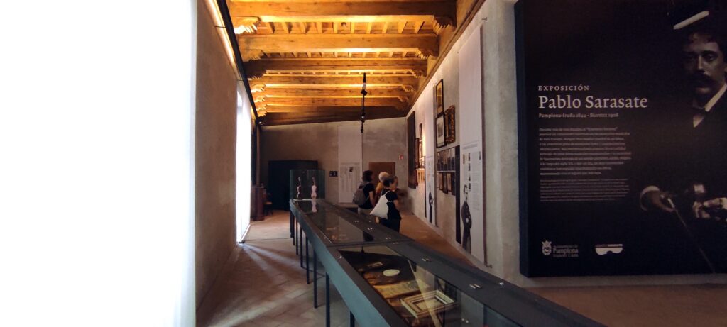 Exhibition hall of the Museo Pablo Sarasate with display cases and timber ceiling, Palacio del Condestable, Pamplona
