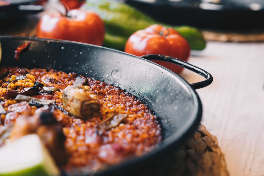 A shared pan of Navarrese rice and tomatoes cooked communally, Pamplona peña kitchen