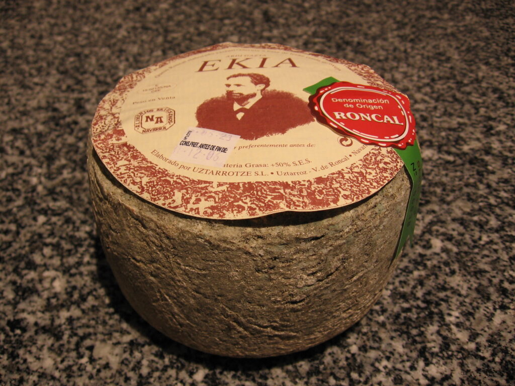 Wheel and cut wedges of Roncal cheese from the Roncal Valley, Navarra