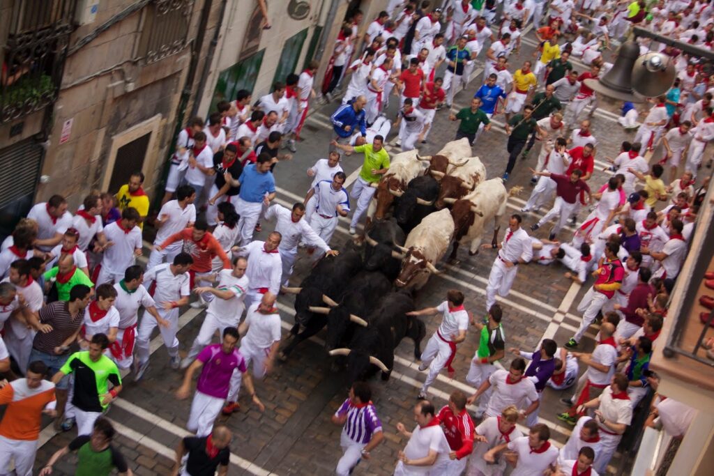 Aerial view of runners and bulls on Estafeta Street during the San Fermín encierro in Pamplona