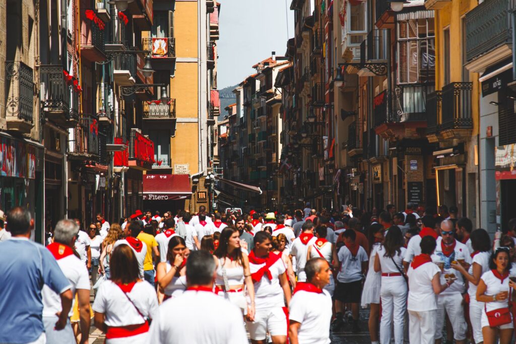 Pamplona peña members in traditional white and red fiesta dress during San Fermín