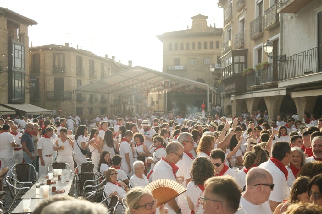 Packed festival crowd filling a historic Pamplona plaza during San Fermín