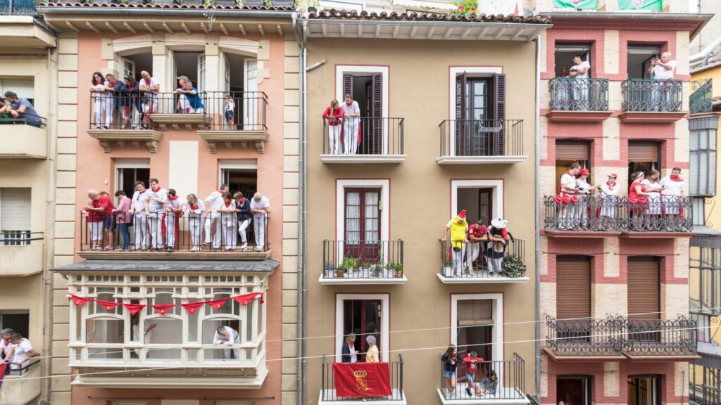 Spectators watching the San Fermin bull run from balconies above the route, Pamplona