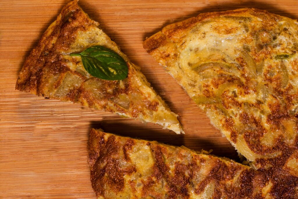 Tortilla de patatas slices on a wooden board, the Spanish omelette of Pamplona's San Fermin almuerzo