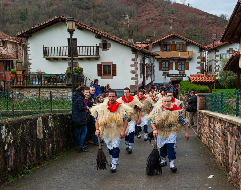Men in traditional Basque Navarra folk costume parading through Ituren, Navarra