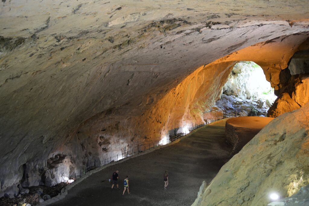 Sunlit mouth of the Cueva de Zugarramurdi cave tunnel in Navarra, Spain